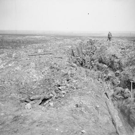 La fanteria britannica occupa un'ex trincea tedesca vicino a Tilloy-les-Mofflaines due giorni dopo la cattura del villaggio, l'11 aprile 1917. Notate due corpi di soldati tedeschi morti nella metà sinistra sepolti nel terreno. © IWM (Q 5144)