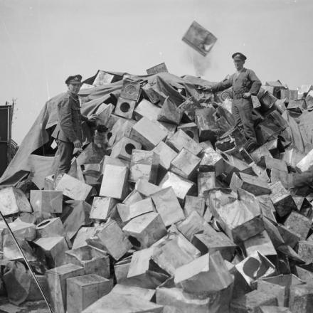 Un cumulo di latte di benzina vuote che devono essere fuse in forni per l'estrazione della lega per saldatura. Etaples, 16 maggio 1918. © IWM  