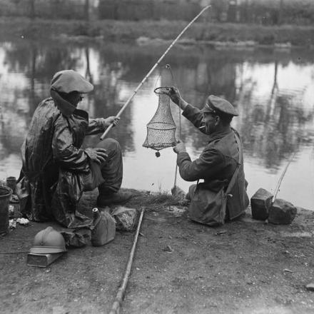 Un soldato francese e un soldato britannico che pescano nel fiume Somme vicino ad Amiens, il 14 luglio 1918. © IWM (Q 11072)