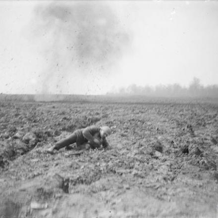 Soldato britannico che si tuffa per proteggersi dopo l'esplosione di un proiettile tedesco. Ayette, aprile 1918. © IWM (Q 6494)