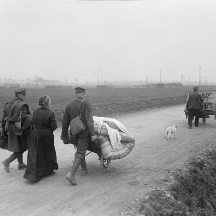 Soldati che assistono una vecchia donna rifugiata sulla strada vicino a Bethune, il 17 aprile 1918. © IWM (Q 10914)