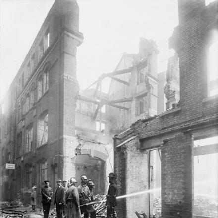 Pompieri tra i resti fumanti a Cox's Court, nella City di Londra, a seguito di un raid aereo il 7 luglio 1917. © IWM (HO 77)